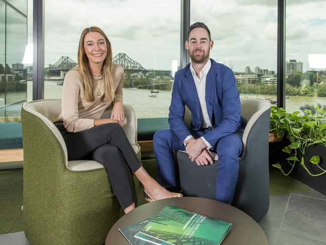 CBRE researcher Ally McDade (left) and agent Dillon Murphy pose for photos in their Eagle Street office, Wednesday, November 8, 2017 (AAP Image/Richard)