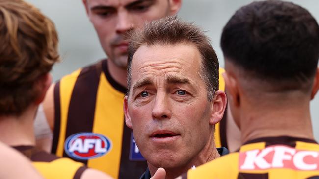 MELBOURNE, AUSTRALIA - AUGUST 21, 2021:    Alastair Clarkson, senior coach of Hawthorn  talks to his team at 3/4 time  during the round 23 AFL match between the Richmond and Hawthorn at the MCG, on August 20, 2021, in Melbourne, Australia. (Photo by Michael Klein)