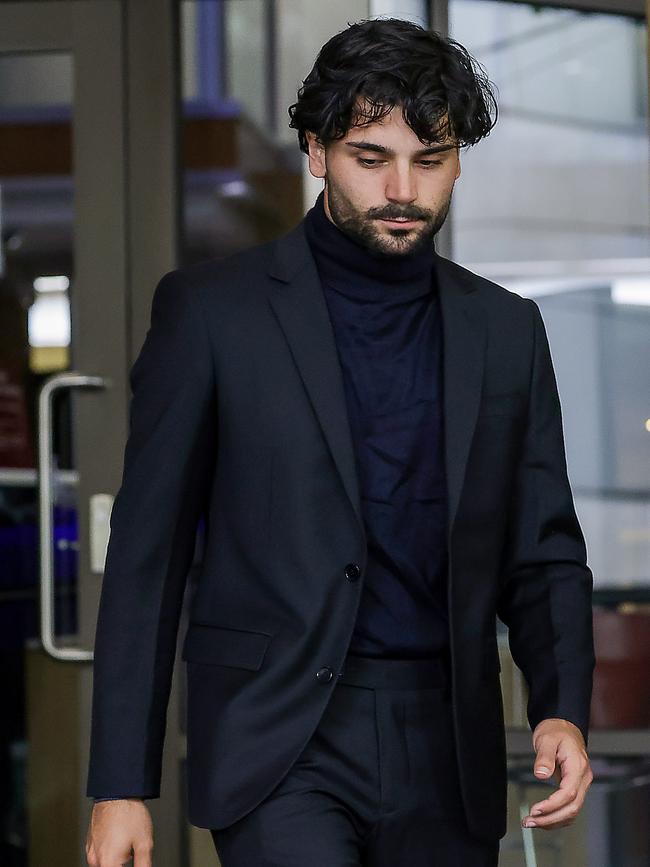 Alexander Grutteria, 23, leaves the Melbourne Magistrates Court after his charges were struck out. He was charged with throwing a bottle at umpire Steven Piperno at Marvel stadium during a clash between Carlton and St Kilda on August 25 last year. Picture: NewsWire/Ian Currie
