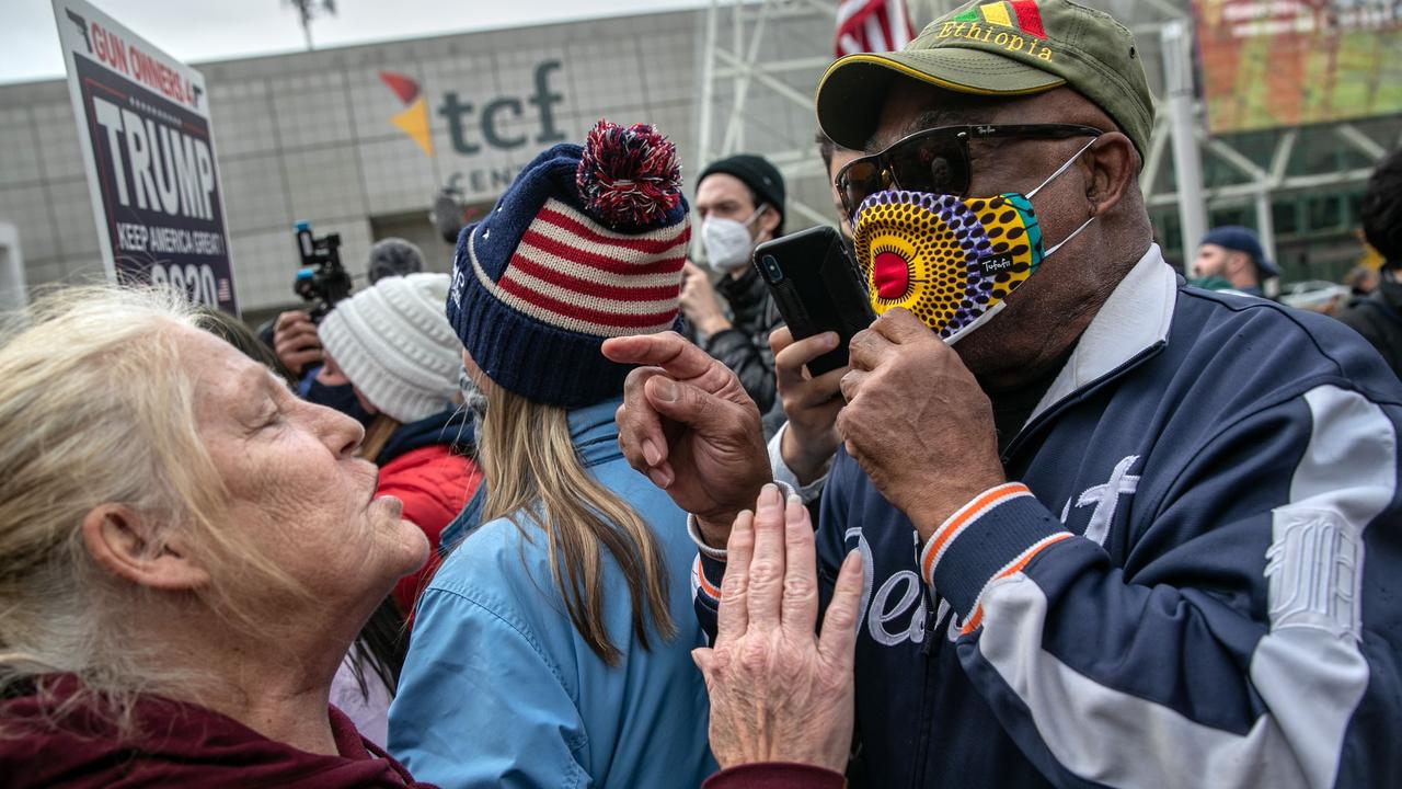 An anti-Trump protester (R), argues with a Trump supporter in Detroit. Picture: John Moore/Getty Images/AFP