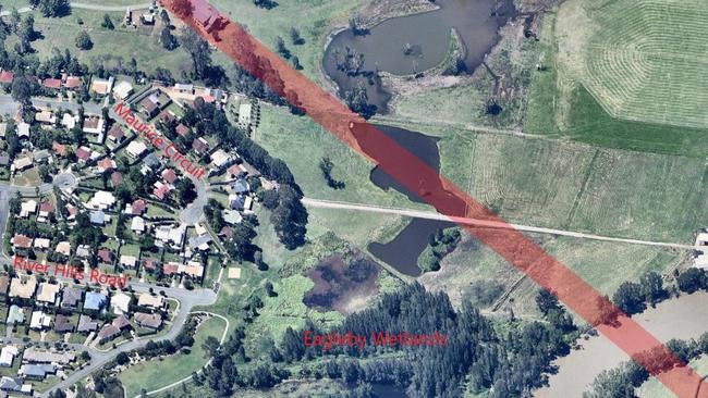 The planned road in red as it would touch the wetlands.