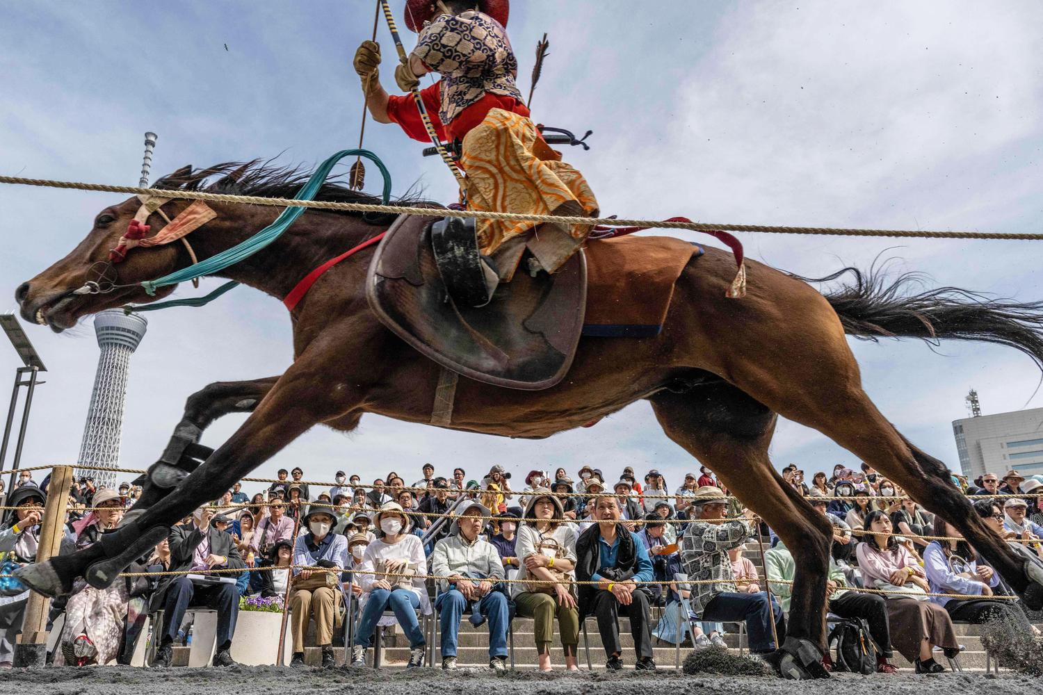 An archer in ancient samurai warrior uniform rides a horse during a Yabusame horseback demonstration at Sumida Park in Tokyo. Picture: Yuichi Yamazaki/AFP