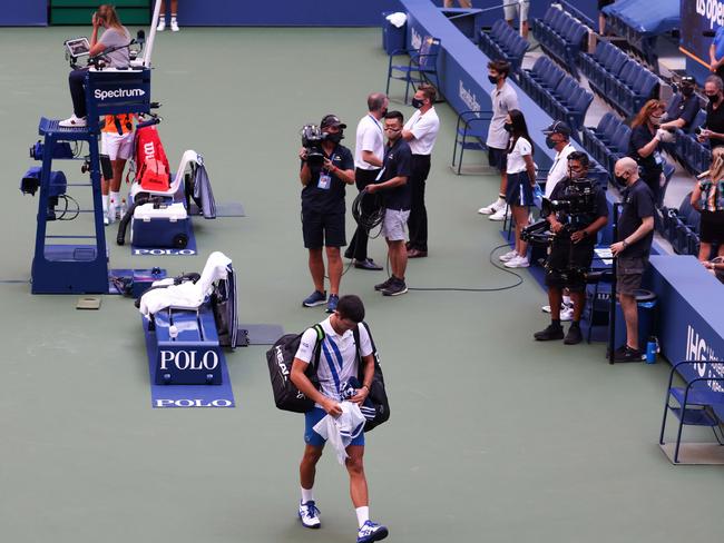 Novak Djokovic walks off the court after being defaulted at the US Open. Picture: AFP.