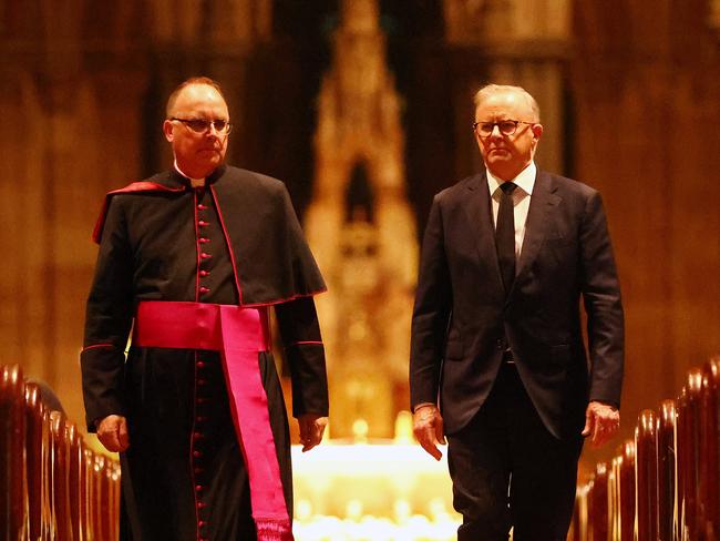 NCA 2025 FEDERAL ELECTION, Labor Bus. April 21, 2025. Australian Prime Minister Anthony Albanese on the campaign trail in Victoria.  The Prime Minister pays his respects following the death of Pope Francis with Monsignor Stuart Hall at St Patricks Cathedral, Melbourne. Picture: Mark Stewart / NewsWire