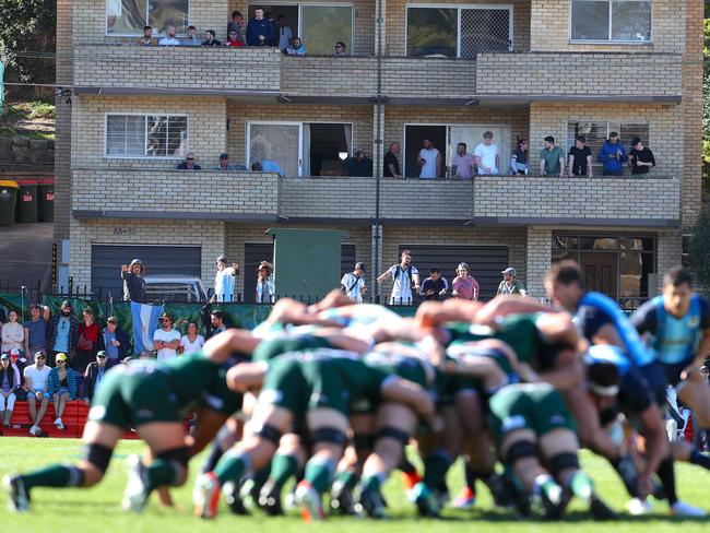 Spectators enjoy the view from an apartment block as Argentina and Randwick players set a scrum. Picture: AAP Image/David Gray