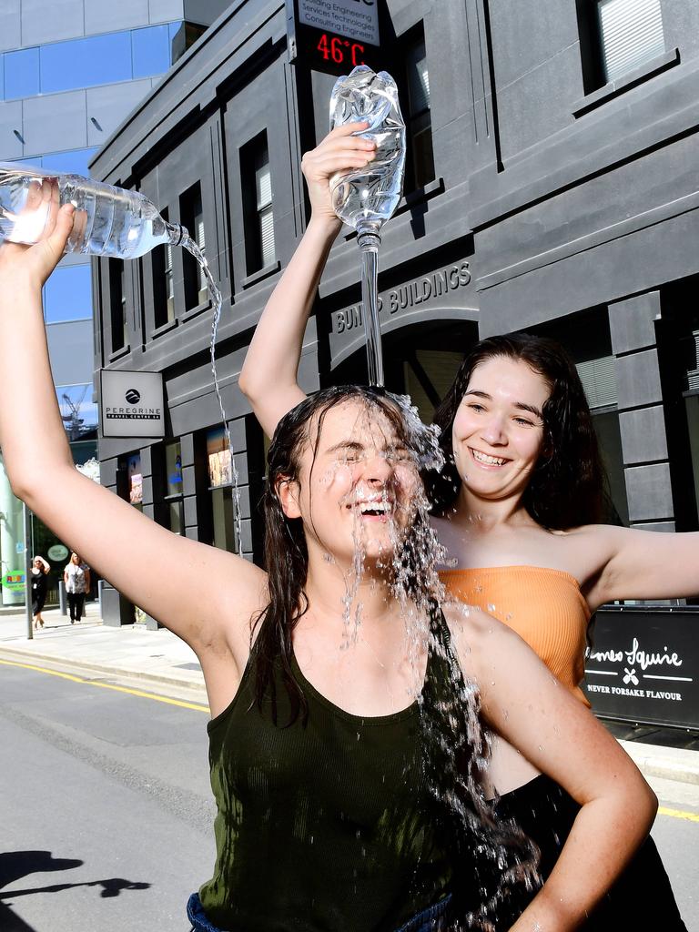 Isabella Fazzini and Bianca Gentilcore cooling down at Gawler Place with a temperature gauge showing 46C. Picture: Mark Brake