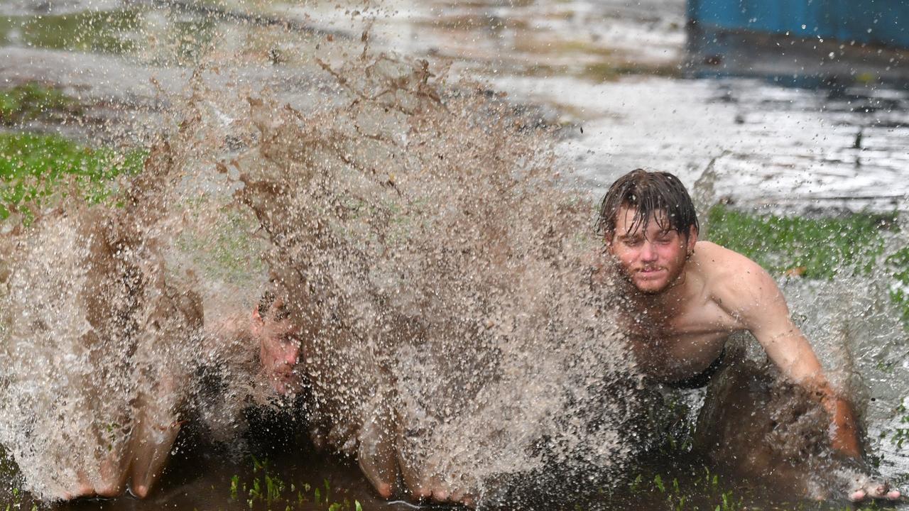 Oscar Mitchell and Lachlan King have fun in a big puddle at Strand Park in Townsville. Picture: Evan Morgan