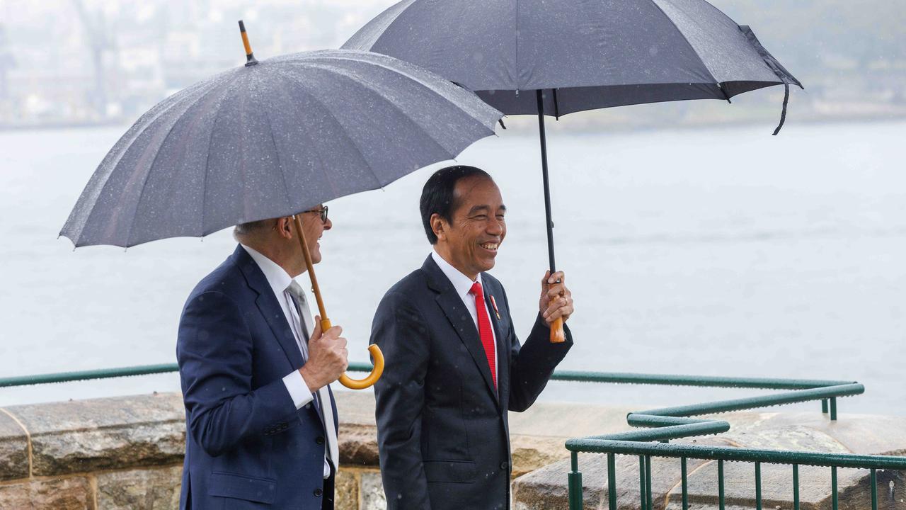 Sydney rain lashed the world leaders as they toured Admiralty House on Tuesday. Picture: NCA NewsWire / David Swift