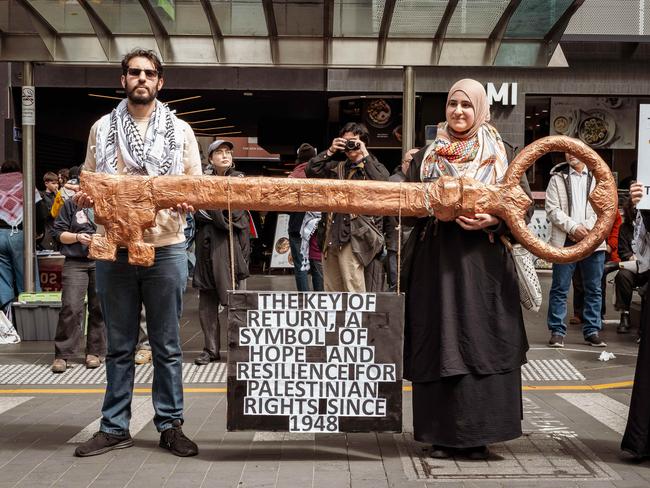 Protesters hold a large symbolic key representing the Palestinian right of return at the pro-Palestine rally in Melbourne. Picture: Tamati Smith