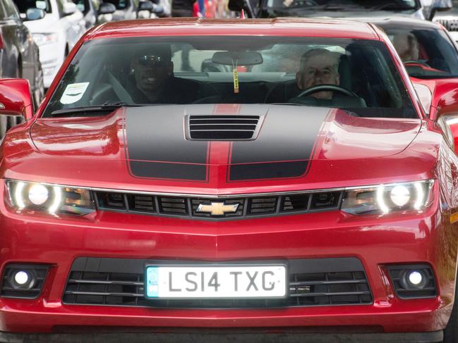 French footballer Paul Pogba (L) arrives in a convoy of vehicles at Manchester United's Carrington training complex, in Manchester, north west England on August 8, 2016. France midfielder Paul Pogba arrived in Manchester on August 8 to complete his record-breaking transfer to Manchester United from Juventus, British media reported. Sky Sports News said the 23-year-old had flown to Manchester from Nice in a private jet and would undergo a medical at United's Training Complex. / AFP PHOTO / OLI SCARFF