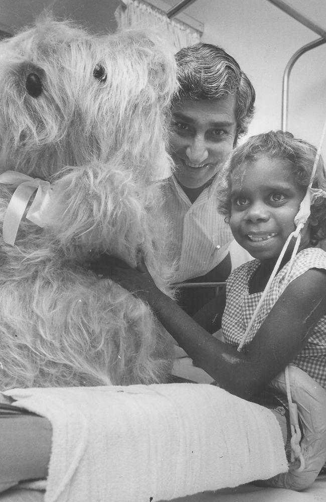 If you were down at Darwin hospital in May 1979, you'd be sure of a big surprise. It was the day that the Minister for Youth, Sport and Recreation, Nick Dondas, presented patients in the children's ward with one big bear and three little ones. Mr Dondas said the bears had been made by a prisoner at Alice Springs jail, Frank Kutchell, an experienced soft toy maker. Mr Dondas is pictured with the big bear and patient Sandra, aged five.