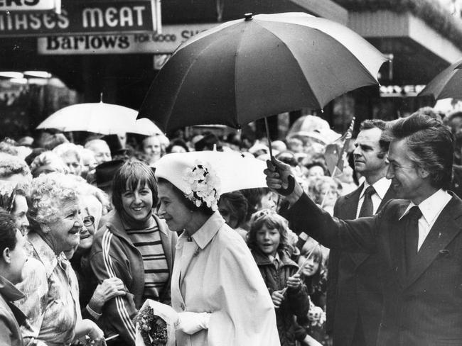 SA Premier Don Dunstan holding an umbrella over the Queen when light rain fell during her 10-minute walk along Rundle Mall.