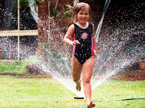 The summer pleasure of running through a sprinkler is banned in Sydney, despite Warragamba Dam almost spilling over.