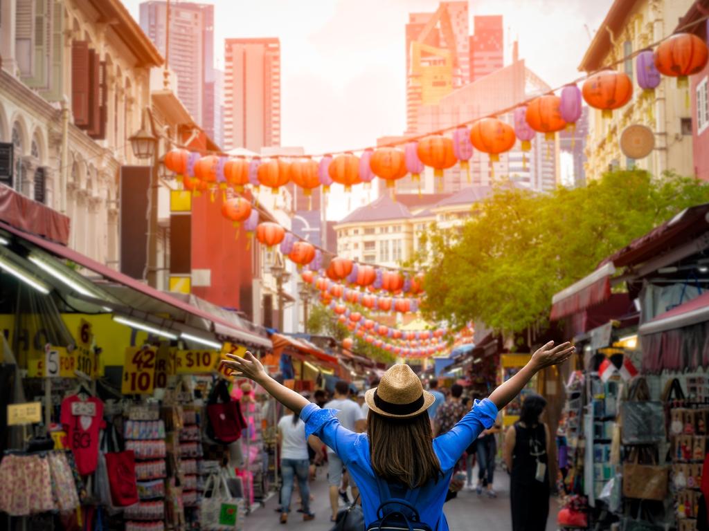 ESCAPE: Singapore -  Young woman traveler with backpack and hat traveling into Chinatown at singapore city downtown. Travelling in Singapore concept. Picture: iStock