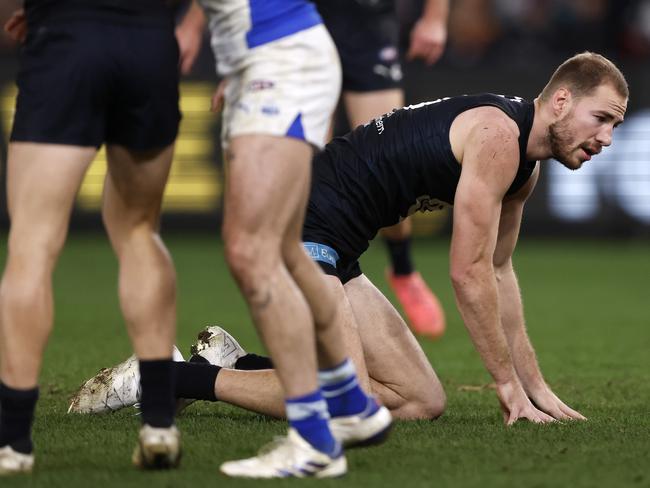 Harry McKay is helped to his feet after a heavy collision against the Roos on Sunday. Picture: Darrian Traynor/Getty Images