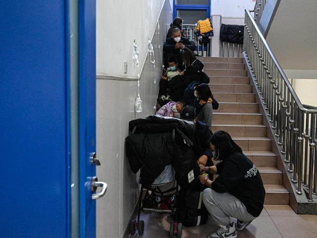 Children receive fluids on the stairs at a children’s hospital in Beijing. Picture: AFP