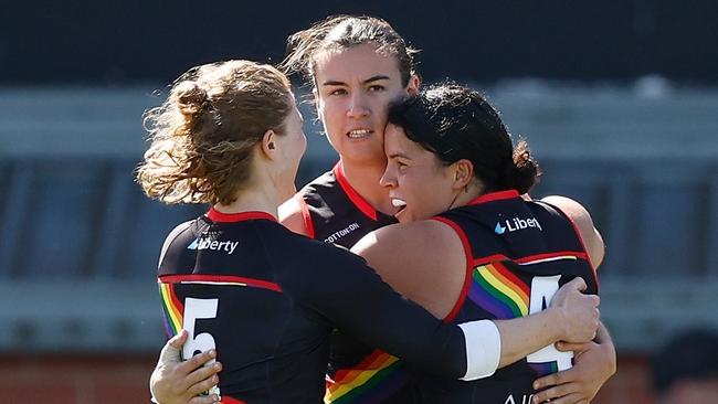 MELBOURNE, AUSTRALIA – OCTOBER 28: (L-R) Georgia Nanscawen, Bonnie Toogood and Madison Prespakis of the Bombers celebrate during the 2023 AFLW Round 09 match between The Essendon Bombers and The Carlton Blues at Windy Hill on October 28, 2023 in Melbourne, Australia. (Photo by Michael Willson/AFL Photos via Getty Images)