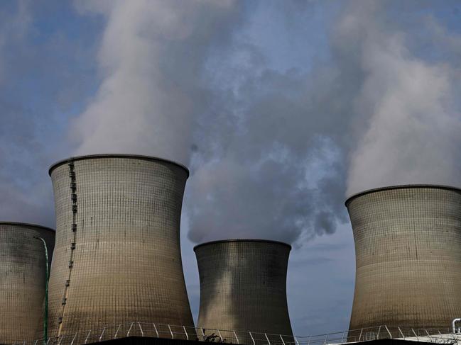 (FILES) This photograph taken on July 24, 2023, shows cooling towers at the Bugey Nuclear Power Plant in Bugey in the Saint-Vulbas commune, eastern France. Driven by a renewed interest in the atom, EDF intends to implement third-generation reactors (EPR) in France and Europe (Photo by Emmanuel DUNAND / AFP)