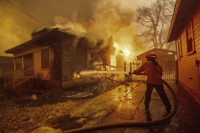 A firefighter battles a blaze in Altadena, California. Picture: AP