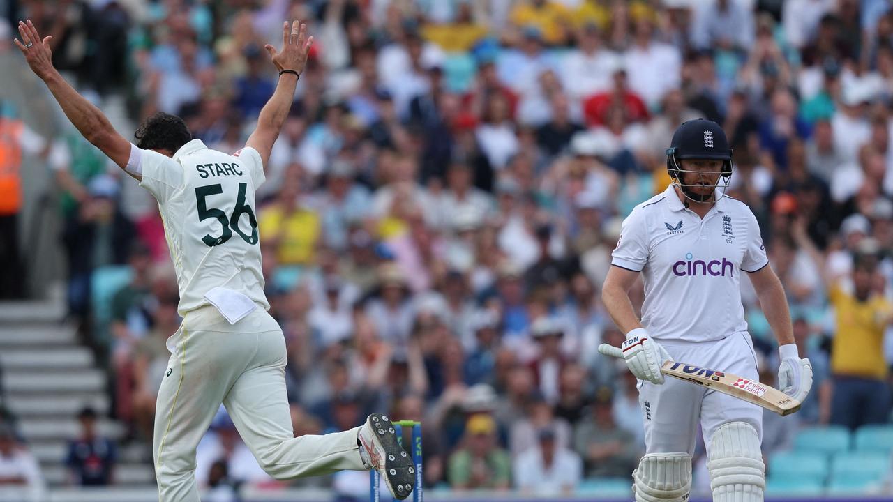 Mitch Starc celebrates the wicket of Jonny Bairstow. (Photo by Adrian DENNIS / AFP)