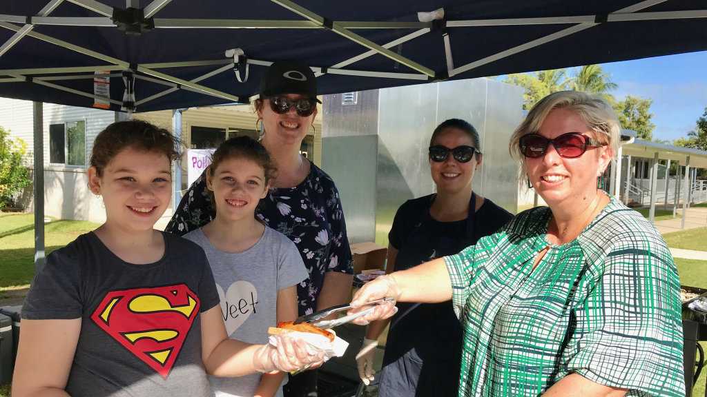 From left, Maya, Evie and Karen Pelchen, Danielle Tasman and Janece Windsor serving up sausages at the Bucasia State School polling station. Picture: Angela Seng