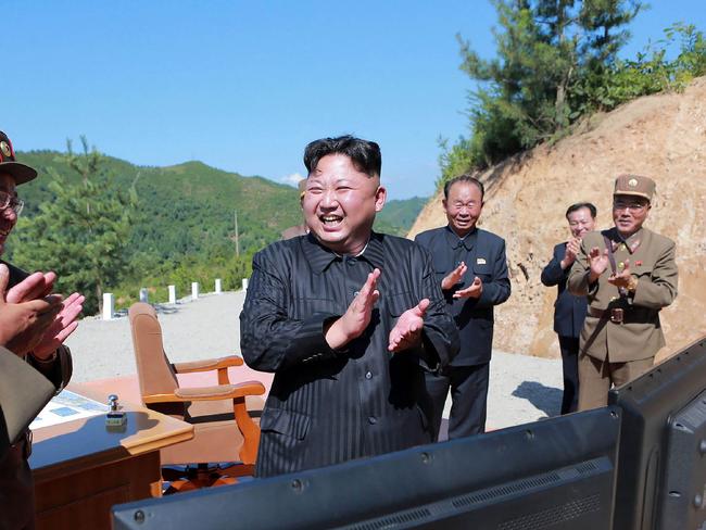 North Korean leader Kim Jong-un celebrates the successful test-fire of an intercontinental ballistic missile. Picture: AFP