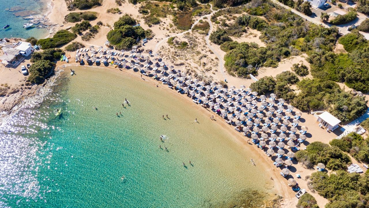 Locals on the Greek island of Paros are fighting to get free beach space back with expensive sun lounges and umbrellas marketed at tourists taking over the sand. Picture: istock