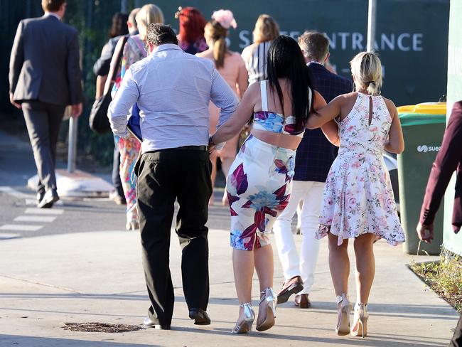People leaving the Melbourne Cup Day at Eagle Farm. Picture: AAP/Richard Gosling