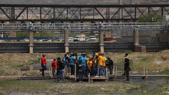 Migrant families participate in the "Hugs, No Walls" event organised by the US organisation Border Network for Human Rights in the middle of the Rio Grande, on the border between El Paso, Texas state, United States, and Ciudad Juarez, Chihuahua state, Mexico, on May 6, 2023. (Photo by Herika Martinez / AFP)