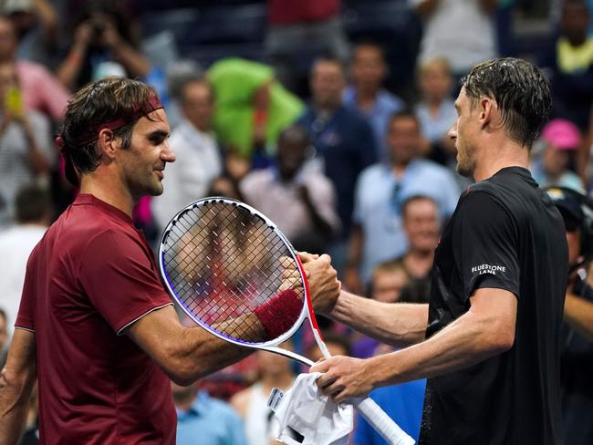 Australia's John Millman (R) shakes hands with Switzerland's Roger Federer. Picture: AFP