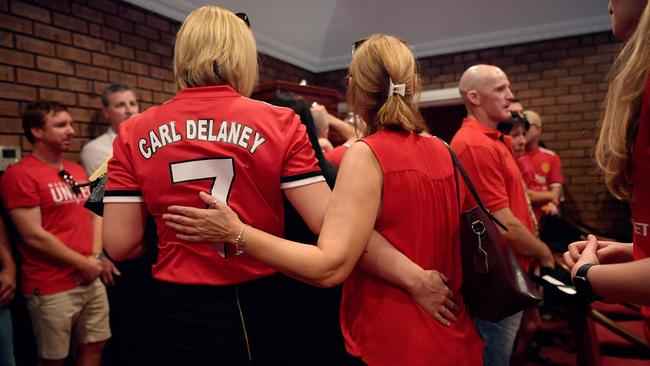 Mourners comfort each other at Carl Delaney’s funeral in December 2017. Picture: Michael Franchi