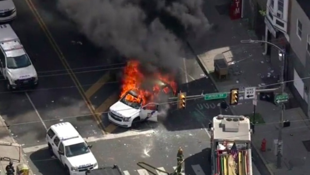 Lines of police cars were smashed and set alight. Picture: FOX29