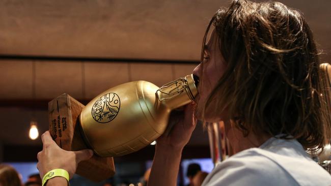 Taking a well earned drink from the custom-made trophy. Photo: Troy Archer