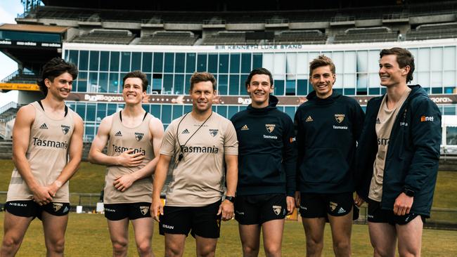 Hawthorn coach Sam Mitchell (third from left) with Hawthorn’s new draft picks at training on Monday.