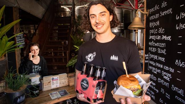 Venue manager Will Taylor from Curl Curl, 4 Pines Brewing Co in Brookvale. Despite COVID-19 restrictions you can still get all your favourites – including a six pack and a burger delivered to your door. Picture: Julian Andrews.