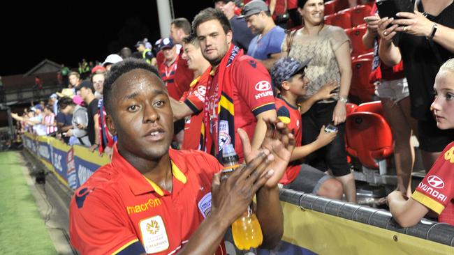 Mark Ochieng of Adelaide United celebrates a win with fans at Hindmarsh Stadium earlier this season. Picture: AAP Image/David Mariuz