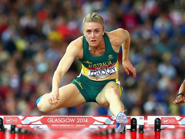 GLASGOW, SCOTLAND - AUGUST 01:  Sally Pearson of Australia on her way to winning gold in the Women's 100 metres hurdles finalat Hampden Park during day nine of the Glasgow 2014 Commonwealth Games on August 1, 2014 in Glasgow, United Kingdom.  (Photo by Ryan Pierse/Getty Images)