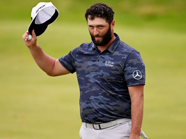 HOYLAKE, ENGLAND - JULY 22: Jon Rahm of Spain raises their cap as they acknowledge the crowd after finishing on the 18th green on Day Three of The 151st Open at Royal Liverpool Golf Club on July 22, 2023 in Hoylake, England. (Photo by Ross Kinnaird/Getty Images)