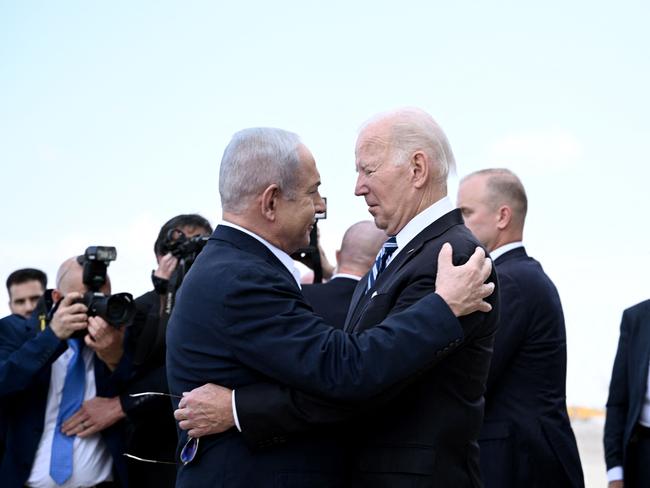 TOPSHOT - Israel Prime Minister Benjamin Netanyahu (L) greets US President Joe Biden upon his arrival at Tel Aviv's Ben Gurion airport on October 18, 2023, amid the ongoing battles between Israel and the Palestinian group Hamas. Biden landed in Israel on October 18, on a solidarity visit following Hamas attacks that have led to major Israeli reprisals. Thousands of people, both Israeli and Palestinians have died since October 7, 2023, after Palestinian Hamas militants based in the Gaza Strip, entered southern Israel in a surprise attack leading Israel to declare war on Hamas in Gaza on October 8. (Photo by Brendan SMIALOWSKI / AFP)