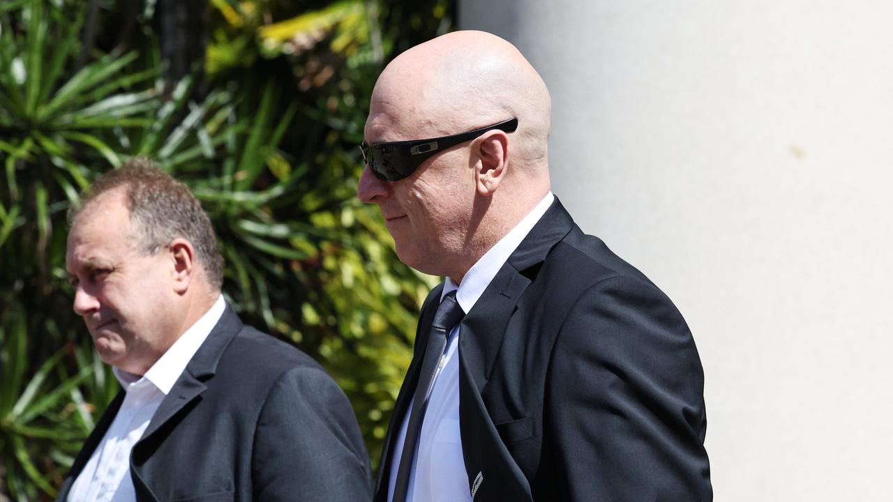 Mt Garnett police officer Sergeant Lee Adam Golding (with sunglasses) leaves the Cairns District Court after pleading not guilty to assault occasioning bodily harm. Picture: Brendan Radke