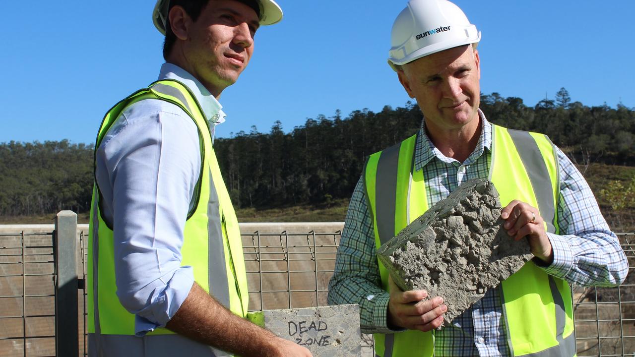 Bundaberg Labor MP Tom Smith and Water Minister Glenn Butcher with a sample of concrete taken from the Paradise Dam spillway in 2021.