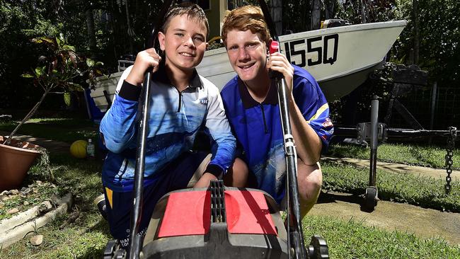 Grade 8 students Daniel McDonald, 13 and Adam Horn, 12 are mowing people's lawns to make cash to buy fishing gear, and have already purchased a boat for $500. PICTURE: MATT TAYLOR.