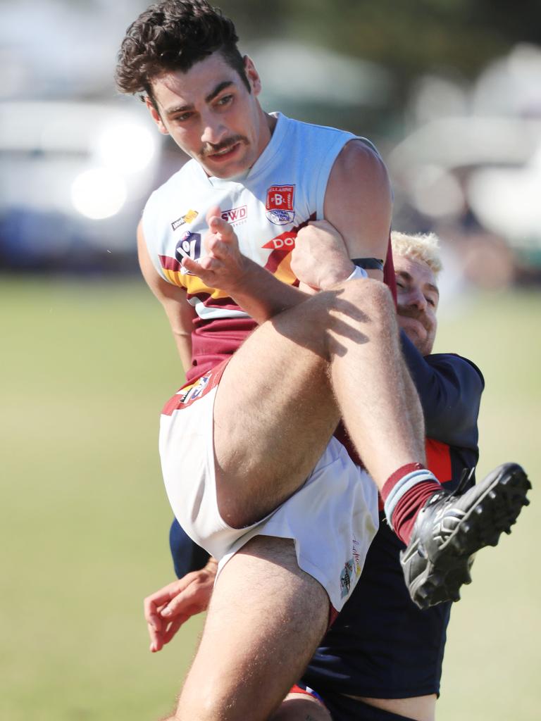 Newcomb’s Ryan Jackman is tackled by Portarlington’s Teia Miles in Round 1. Picture: Mark Wilson