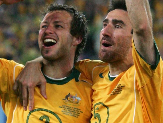 SYDNEY, NSW - NOVEMBER 16:  Lucas Neill #2 and Tony Vidmar #5 for the Socceroos celebrates after winning the second leg of the 2006 FIFA World Cup qualifying match between Australia and Uruguay at Telstra Stadium November 16, 2005 in Sydney, Australia.  (Photo by Robert Cianflone/Getty Images)