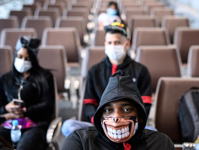 A man wearing a face mask as a preventive measure following sits at the Kai Tak cruise terminal where the World Dream cruise ship is docked. Picture: AFP