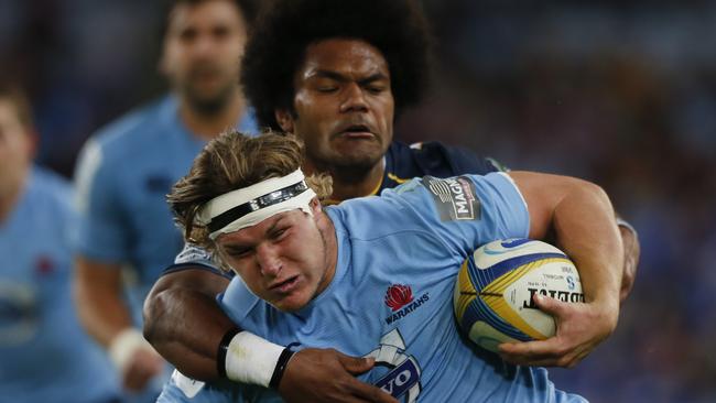 Waratahs flanker Michael Hooper tries to break out of Henry Speight’s tackle.