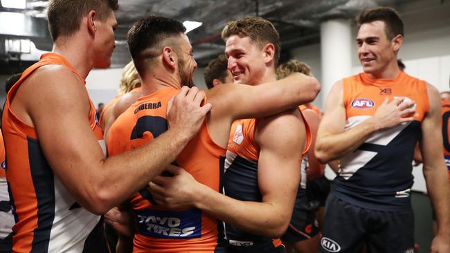 Stephen Coniglio gives teammate Jacob Hopper a hug after the Giants beat the Swans. Picture: Getty Images