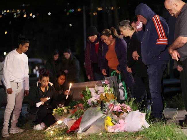 SEPTEMBER 3, 2023: People pictured at a candle light vigil at the cash scene in Heckenberg where two people were killed around 9.20pm (Friday 1 September 2023). Picture: Daily Telegraph