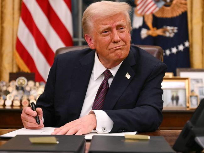 President Donald Trump signs executive orders in the Oval Office of the White House. Picture: Jim Watson