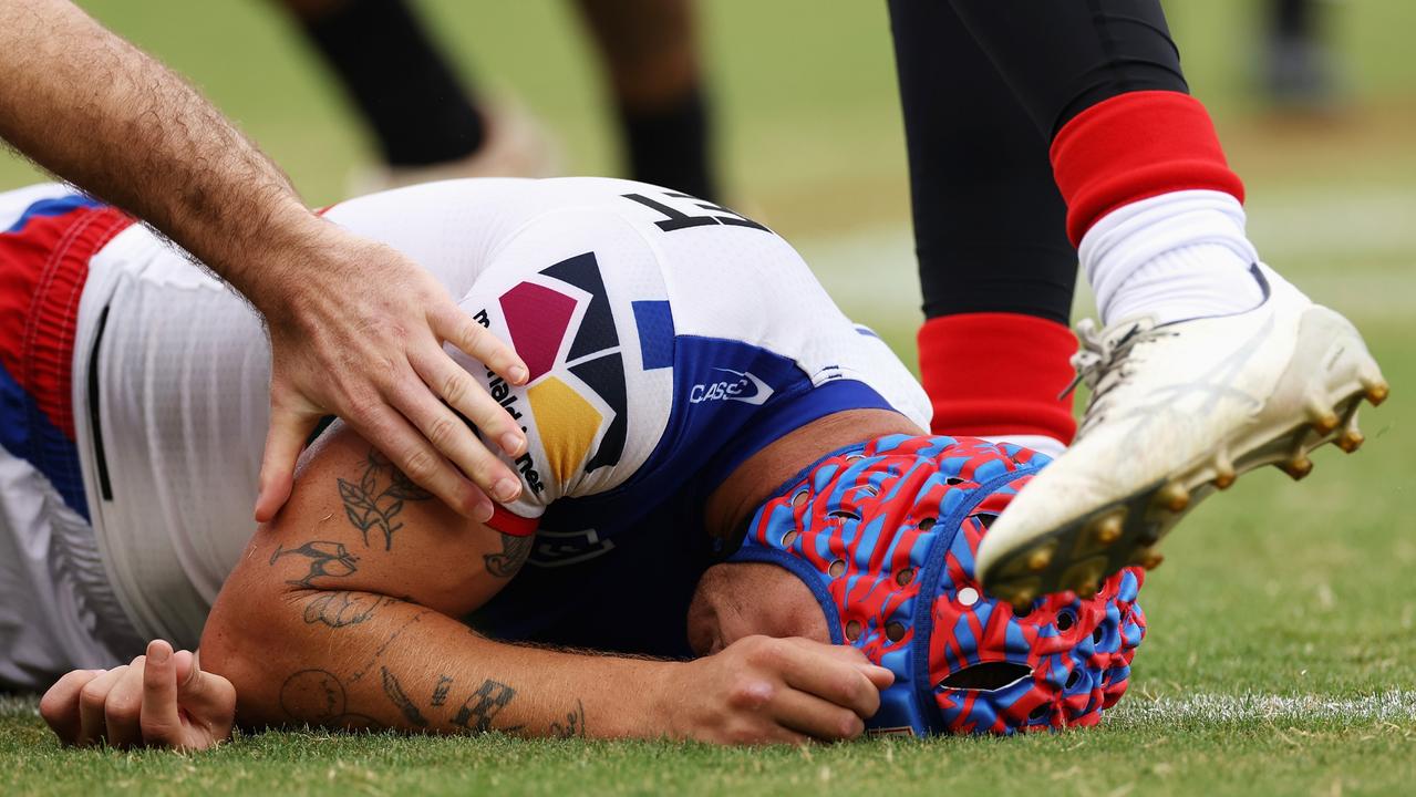 Kalyn Ponga of the Knights lays on the ground after colliding with Asu Kepaoa of the Tigers (Photo by Cameron Spencer/Getty Images)